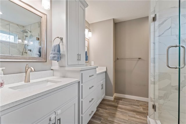 bathroom with an enclosed shower and vanity