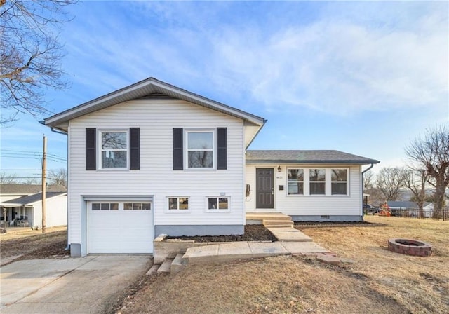 split level home with a garage and a fire pit