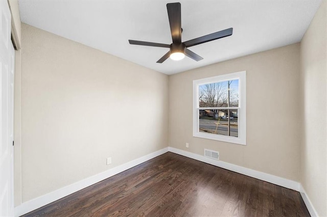 unfurnished room with dark hardwood / wood-style floors and ceiling fan