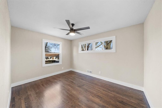 empty room featuring dark hardwood / wood-style floors and ceiling fan