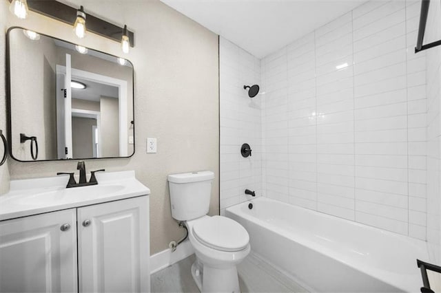 full bathroom with tiled shower / bath, vanity, and toilet