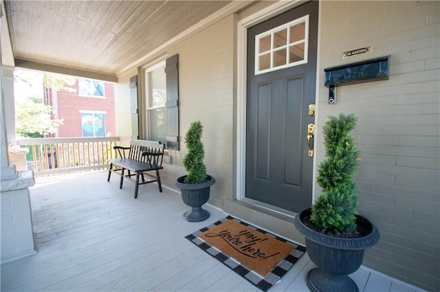 doorway to property featuring covered porch