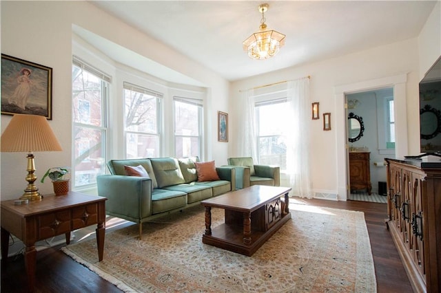 interior space with a notable chandelier and dark hardwood / wood-style flooring