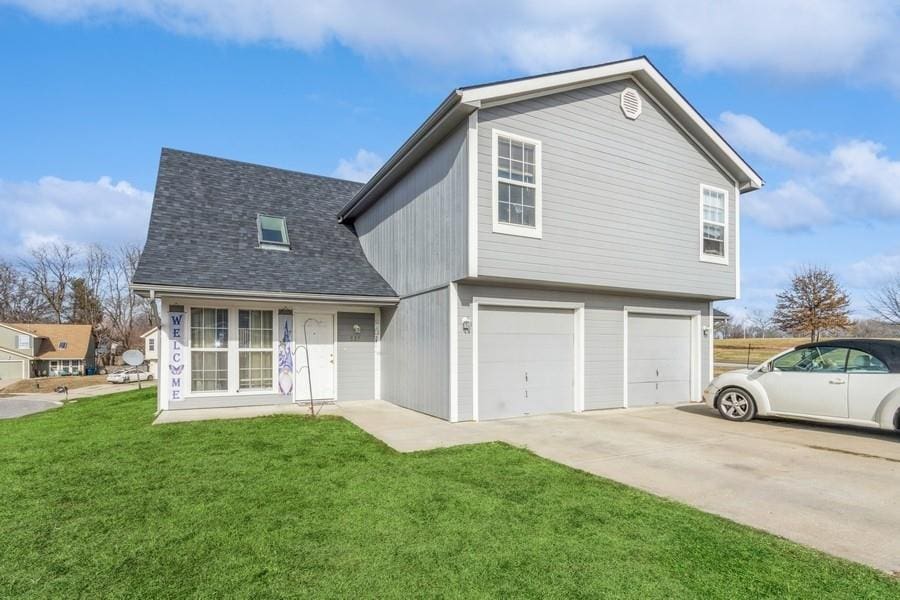 view of front property with a garage and a front yard