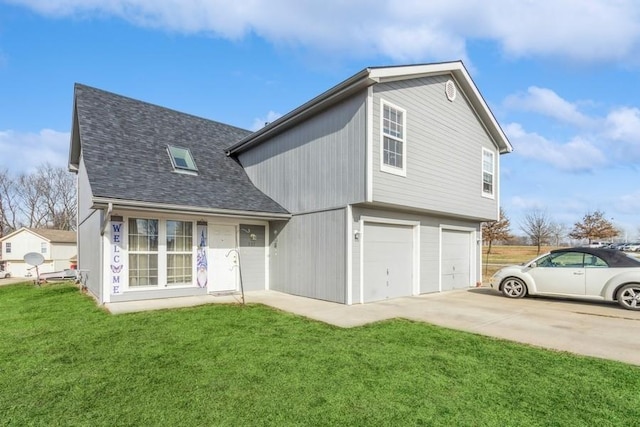 back of house featuring a yard and a garage