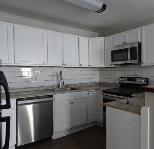 kitchen featuring white cabinetry, stainless steel appliances, sink, and tasteful backsplash