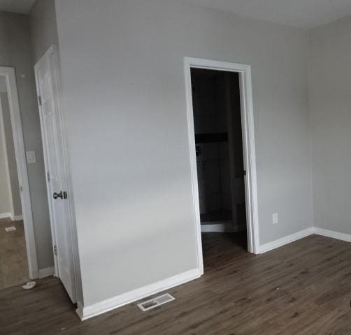 empty room with dark hardwood / wood-style floors