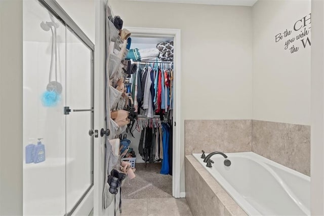 bathroom featuring tile patterned floors and independent shower and bath