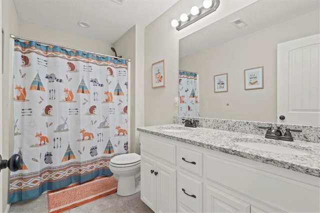 bathroom featuring vanity, curtained shower, and toilet