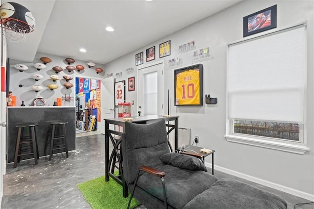 playroom with indoor bar and concrete floors