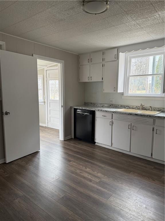 kitchen with dark wood-style floors, light countertops, dishwasher, and white cabinetry