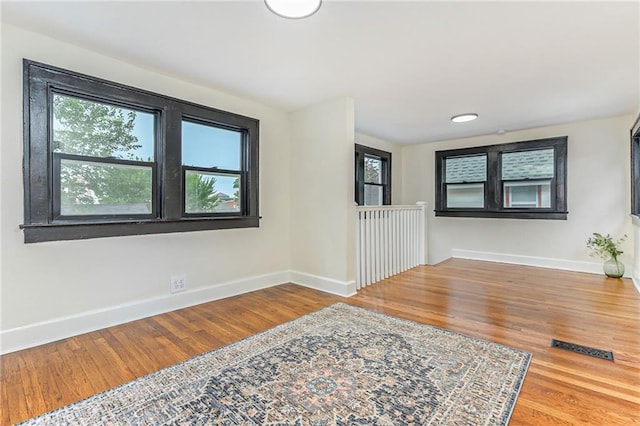 foyer entrance with hardwood / wood-style flooring and plenty of natural light