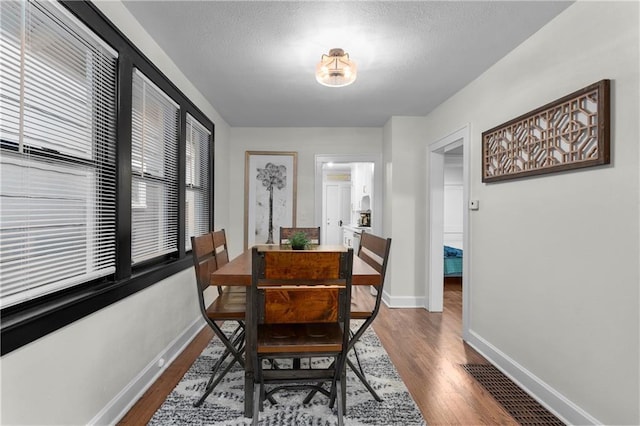 dining space with hardwood / wood-style flooring