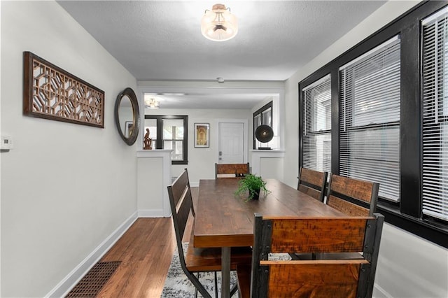 dining area with hardwood / wood-style floors