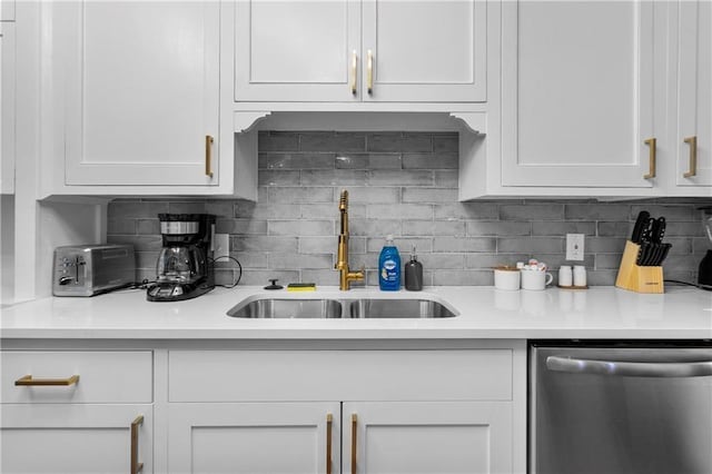 kitchen featuring white cabinetry and dishwasher