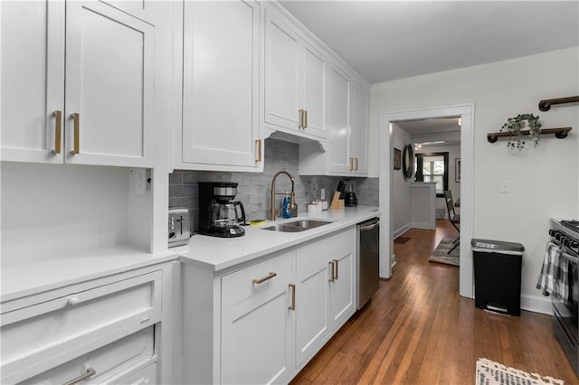 kitchen with sink, white cabinetry, tasteful backsplash, dark hardwood / wood-style flooring, and dishwasher