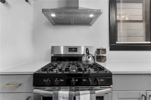 kitchen featuring stainless steel range with gas stovetop and wall chimney range hood