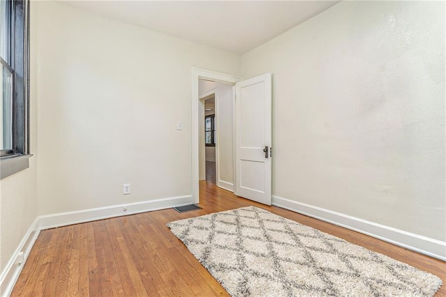 empty room with wood-type flooring