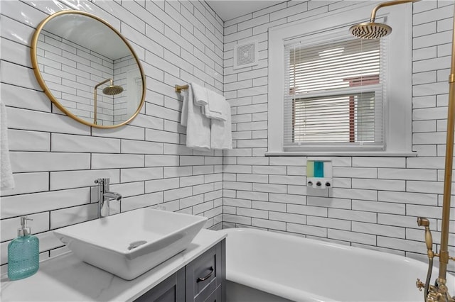 bathroom with vanity, tile walls, and  shower combination