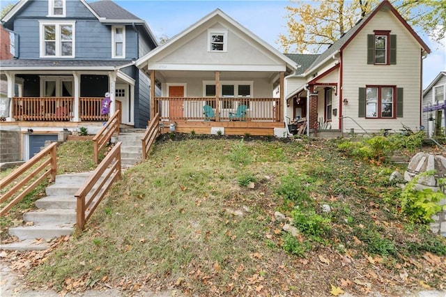 back of property with a lawn and covered porch