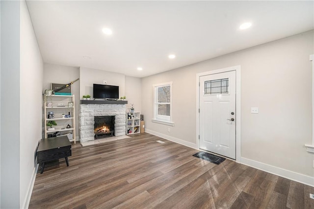 living room featuring wood-type flooring and a fireplace