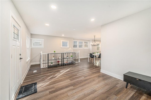 interior space with an inviting chandelier and wood-type flooring