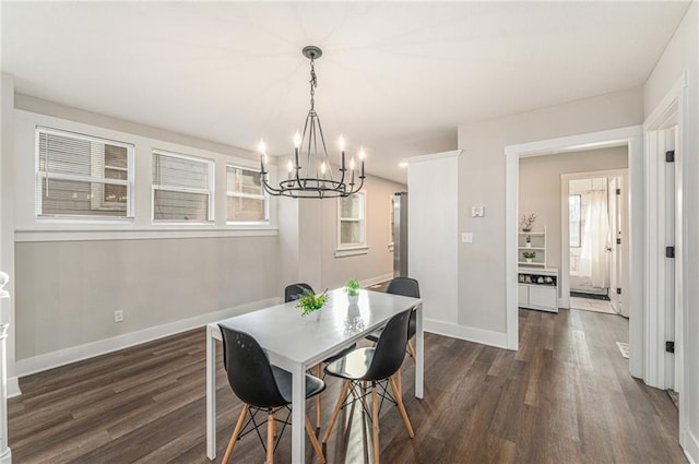 dining area with a chandelier and dark hardwood / wood-style flooring