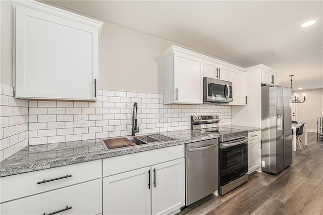 kitchen featuring appliances with stainless steel finishes, sink, and white cabinets