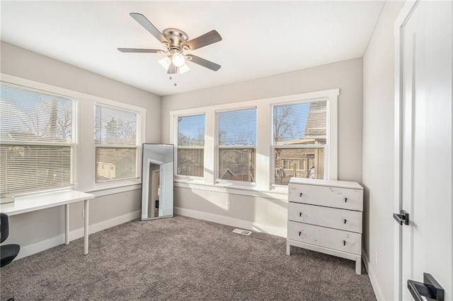 interior space with carpet floors and ceiling fan