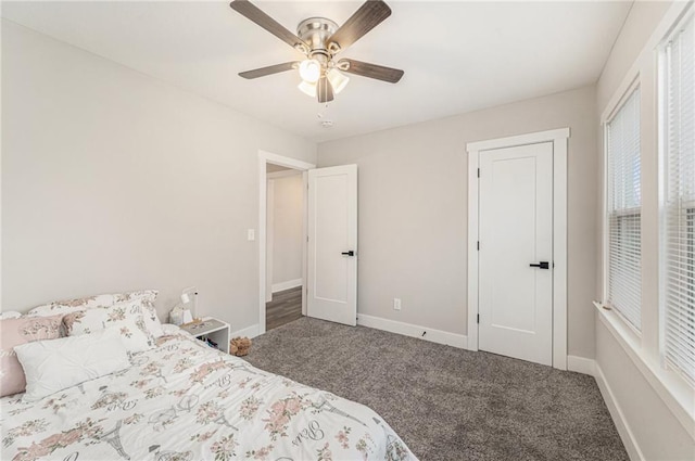 bedroom featuring ceiling fan and dark carpet