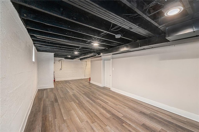 basement featuring wood-type flooring