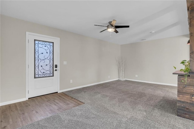 entrance foyer with ceiling fan and carpet flooring