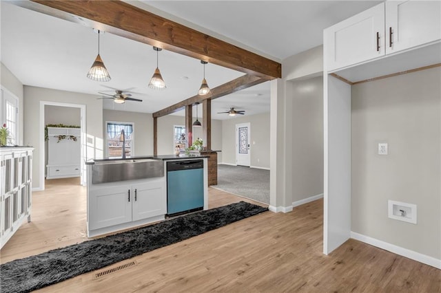 kitchen featuring light hardwood / wood-style flooring, hanging light fixtures, stainless steel dishwasher, beam ceiling, and white cabinets