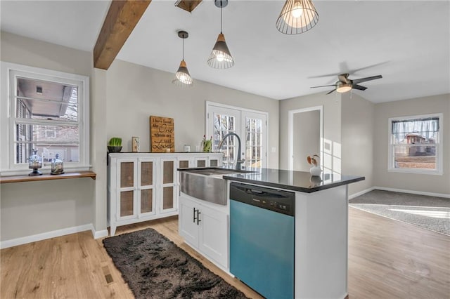 kitchen featuring sink, white cabinetry, hanging light fixtures, a kitchen island with sink, and stainless steel dishwasher