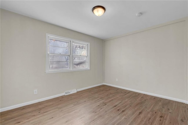 spare room with light hardwood / wood-style floors