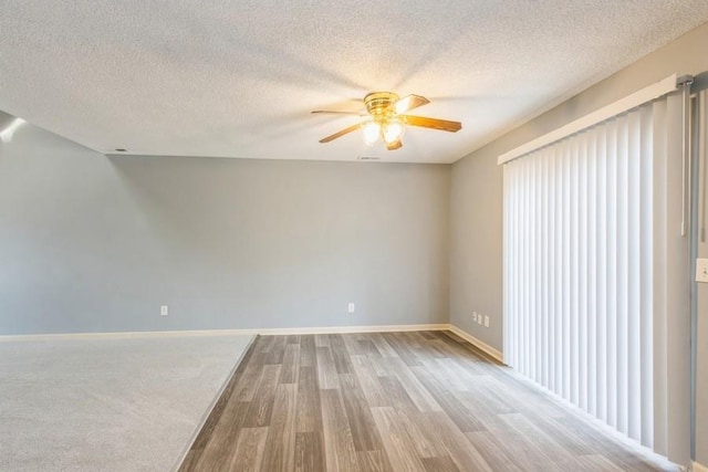 spare room featuring hardwood / wood-style flooring, plenty of natural light, a textured ceiling, and ceiling fan