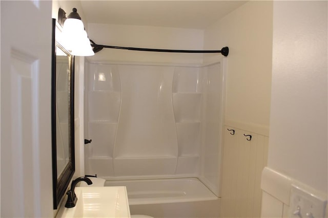 bathroom with shower / bathing tub combination and a sink