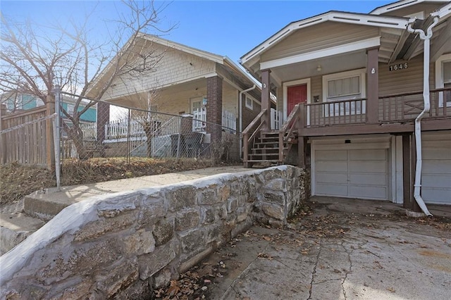 view of front of house with a porch and a garage