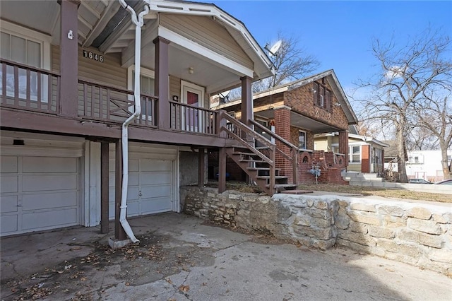 view of property exterior with a garage and a porch