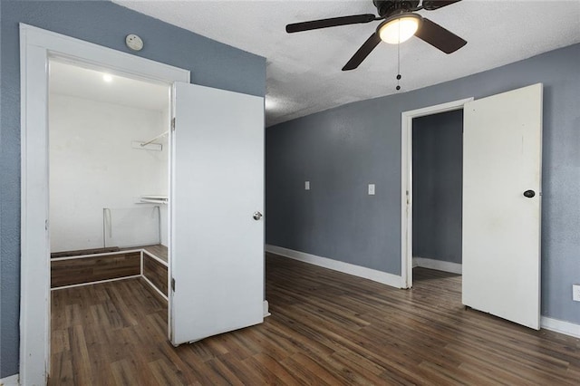 interior space featuring dark wood-type flooring and ceiling fan