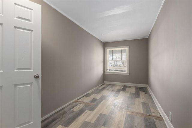 unfurnished room with ornamental molding and hardwood / wood-style floors