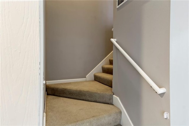 stairway featuring carpet flooring, visible vents, and baseboards