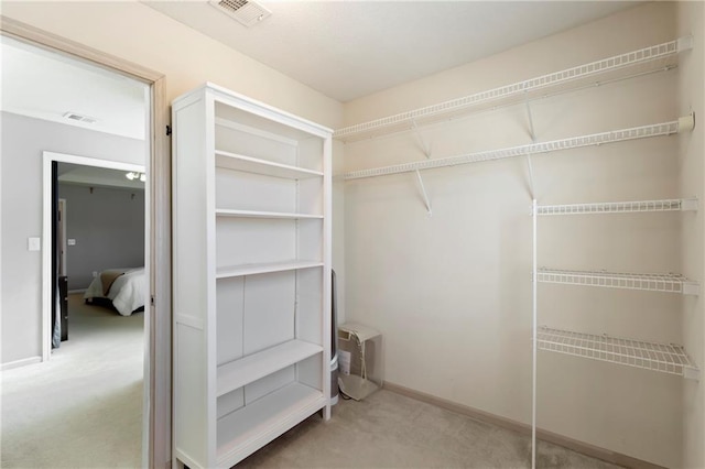 spacious closet with carpet floors and visible vents