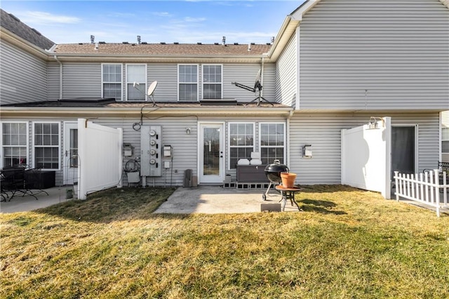 back of house with a patio, a lawn, and fence