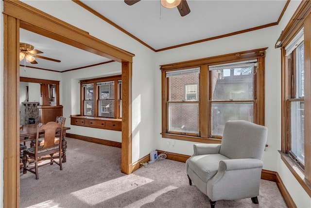 sitting room featuring ornamental molding, light colored carpet, and ceiling fan