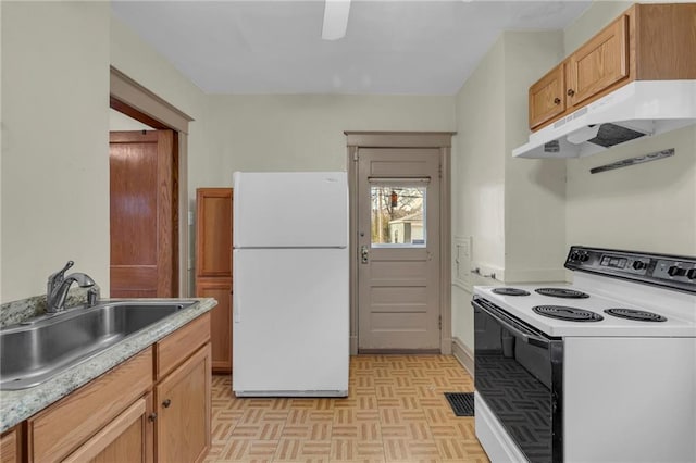 kitchen featuring light parquet floors, sink, and white appliances