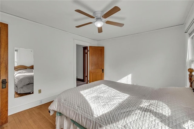 bedroom with light hardwood / wood-style flooring and ceiling fan