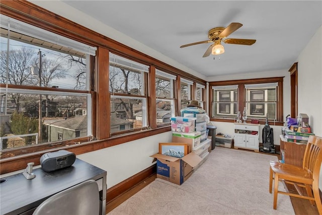 interior space featuring light carpet and ceiling fan