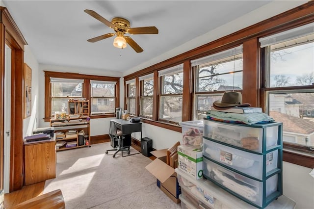 carpeted home office with ceiling fan