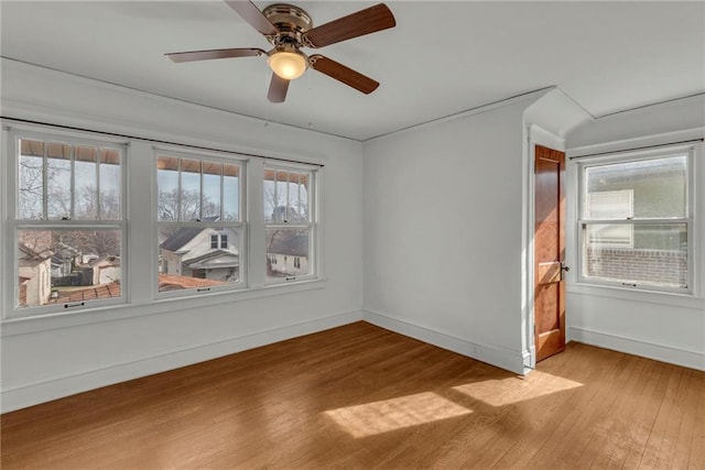 spare room with ceiling fan and light wood-type flooring